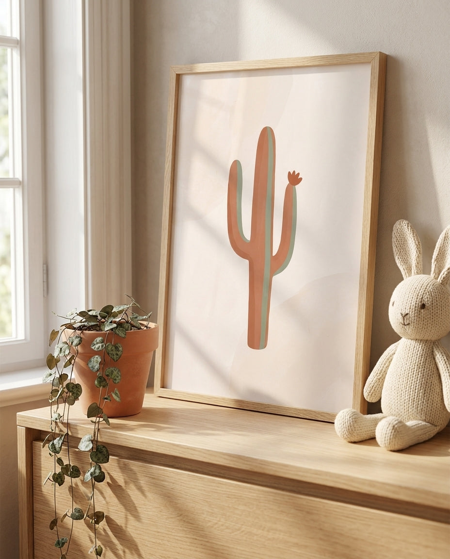 Desert nursery print leaning on a wooden dresser with a plant